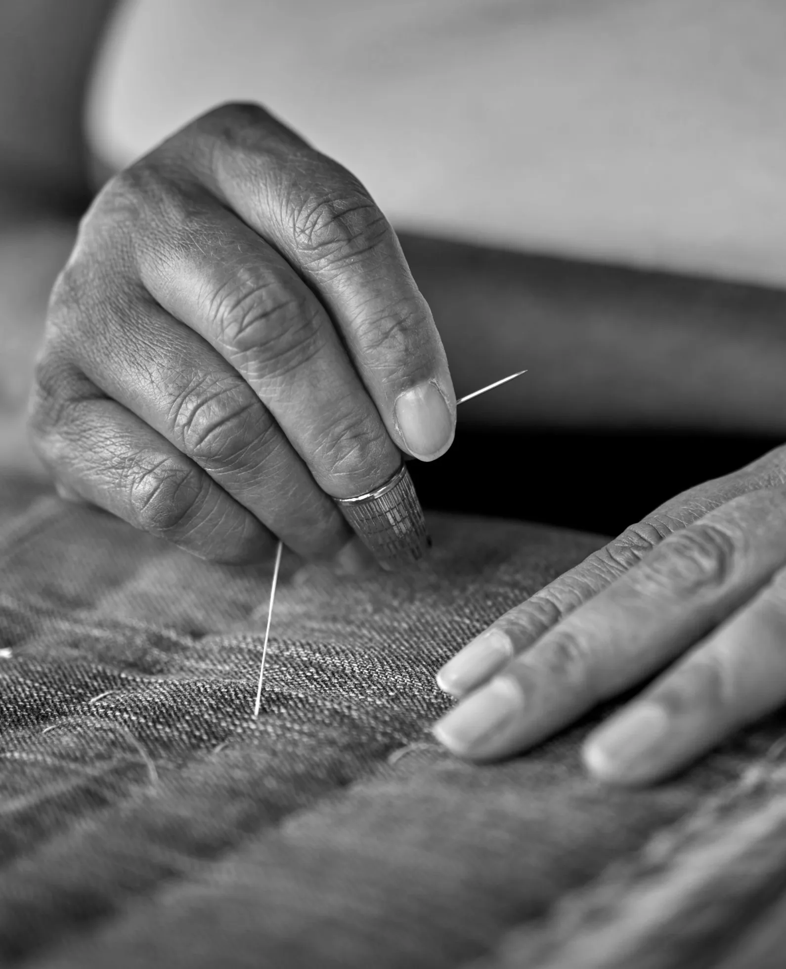 Hands stitching a quilt