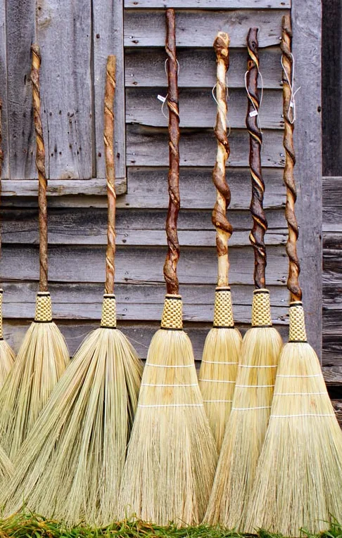 Finished brooms against barn wood