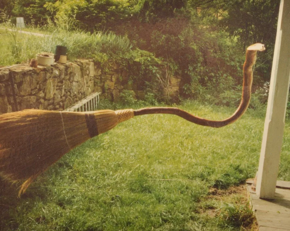 A broom with a curved handle
