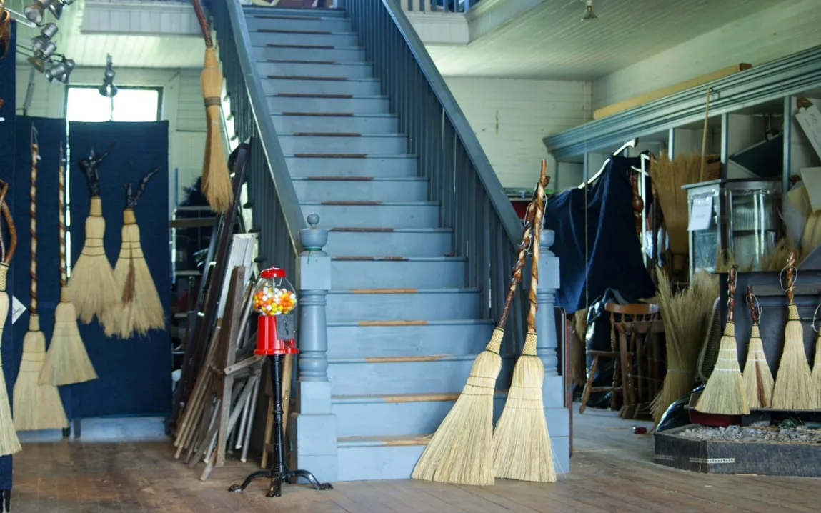 Brooms hanging by the staircase