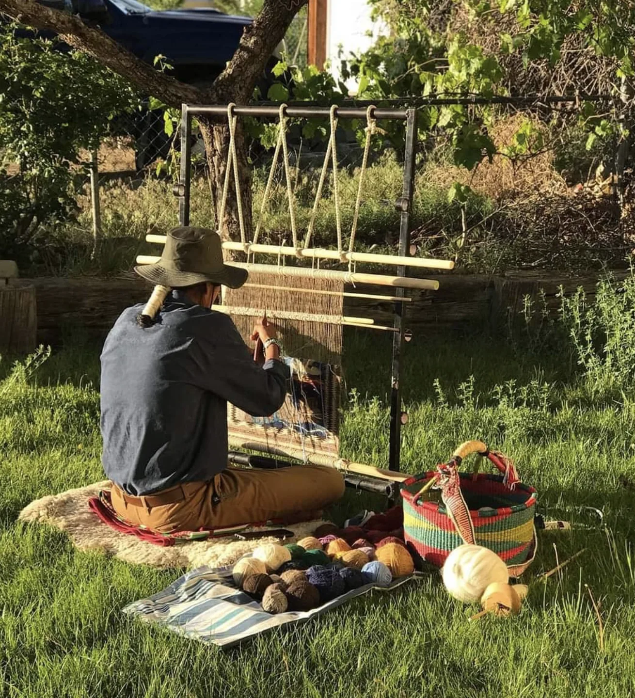 Tyrrell Tapaha weaving at an upright loom